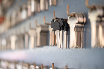 Close up of key hanging on wall in key maker shop