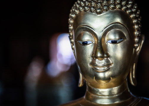 Selective focus close-up shots of Buddha statues that are used as amulets of Buddhism	