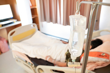 Focus on saline solution of a patient in hospital room