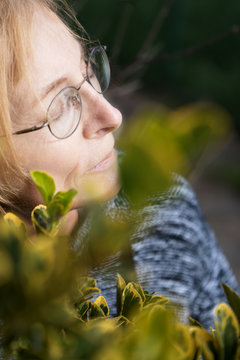 Senior Woman With Closed Eyes Enjoys Outside With Face Towards The Sun