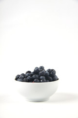 a bowl of blueberry isolated on white background. Vertical image