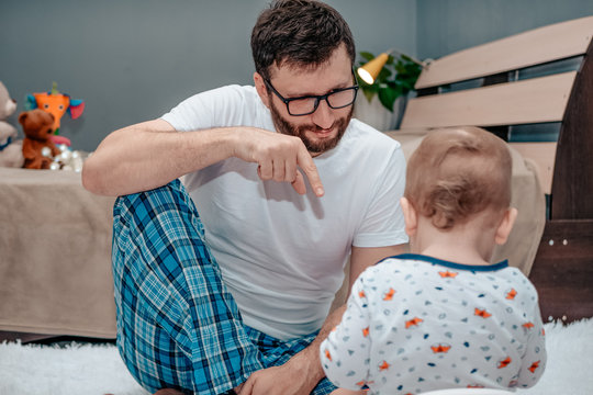 Father And Son. Father Teaches A Child To Walk On A Potty. Father Shows How To Do It Right. Dad Points A Finger. The Child Is Playing. Baby Toiletries. Potty Training.