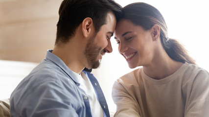 Happy young couple hug enjoying romance at home