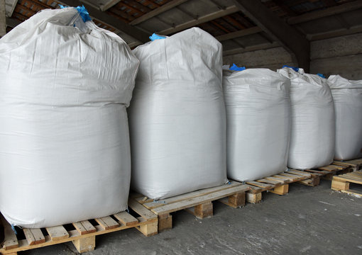 Warehouse with large bags on pallets.