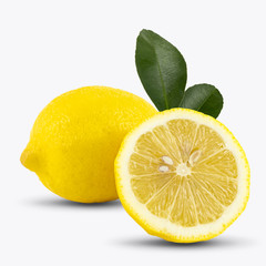 Whole lemon fruit and a half with leaf isolated on white background, with clipping paths.