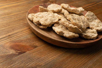 Raw Dehydrated Soy Meat or Soya Chunks on Wood Background