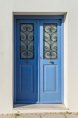 Old wooden door of an mediterranean house, vintage background.