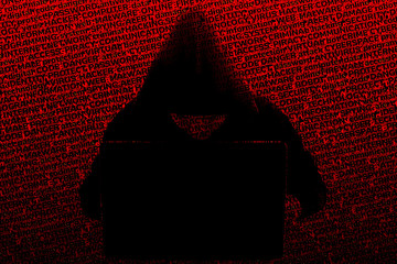 The silhouette of a hooded hacker working at a laptop, against a background of bright blood-red...