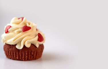 custard cake decorated with hearts on a white background. place for text.