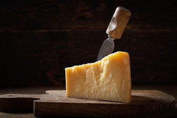 piece of parmesan cheese on a wooden background