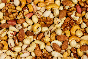 Background of mixed nuts (walnuts, pistachio, almond, peanut, cashew, hazelnut). Healthy eating concept