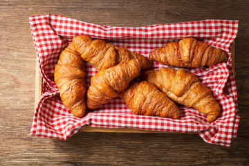 fresh croissants on a wooden table