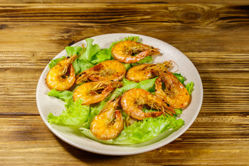 Tasty baked shrimps on a wooden table