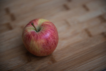Fresh rustic apple on a wooden background