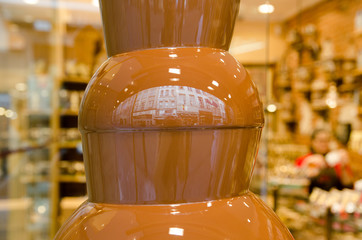 The chocolate fountain at a sweets store. Belgium