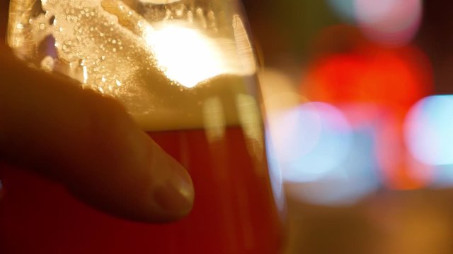 beer glass on table in bar. lights and beautiful bokeh on blurred background