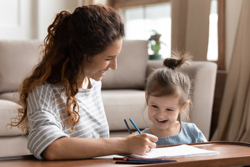 Pretty happy woman engaged in early child education.
