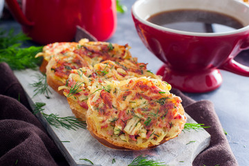 Hot sandwiches with potatoes and sausage without cheese, cooked in a pan, selective focus