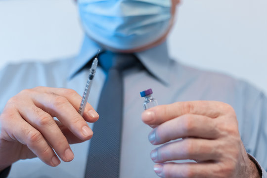 Coronavirus quarantine and Air pollution pm2.5 concept. Old sick man wearing respirator mask for protect holds syringe and medicine for injection. Wuhan, China epidemic virus symptoms background.