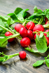 Fresh radish radishes on a wooden background, seasonal vegetables healthy food. vitamin salad recipe