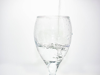 Pour water into the glass until small bubbles of various shapes are formed. White background