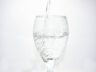 Pour water into the glass until small bubbles of various shapes are formed. White background