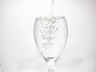 Pour water into the glass until small bubbles of various shapes are formed. White background