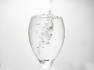 Pour water into the glass until small bubbles of various shapes are formed. White background