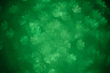 Fototapeta na wymiar Clover shaped bokeh. St.Patrick 's Day. Blurred abstract background. Green shamrock