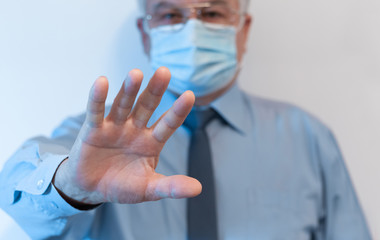 Stop coronavirus, quarantine and Air pollution pm2.5 MERS-Cov Novel 2019 concept. Old man wearing respirator mask for protect with arms outstretched. Wuhan, China epidemic virus symptoms background.