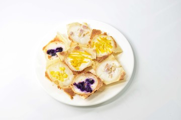 khanom khrok,Thailand desserts  made from coconut milk, filled with a lilac pumpkin in a white plate.