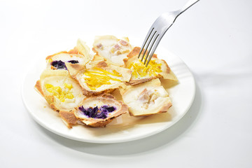 khanom khrok,Thailand desserts  made from coconut milk, filled with a lilac pumpkin in a white plate.