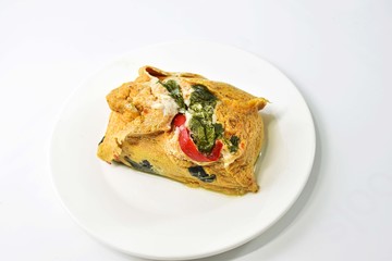 Thai Steamed Curried Fish in banana leaf placed on a white dish.