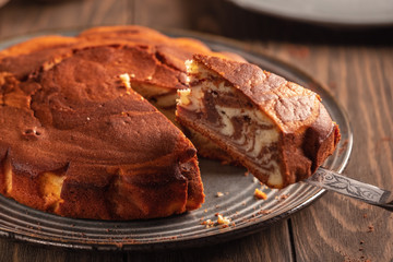 Homemade baking. Fragrant zebra cake with a crispy crust on a plate with coffee and chocolate