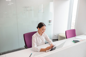 Asian woman is working in office