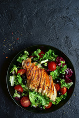 Grilled chicken fillet with vegetable salad. Top view with copy space.