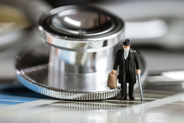 Mini Figure business people, tourist man wearing surgical mask protective Coronavirus 2019-ncv, flu virus prevention infectious on stethoscope medical, Chinese coronavirus outbreak WUHAN virus concept