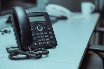 Selective focus IP phone on desk office ,phone for comunication,Bussiness and finance