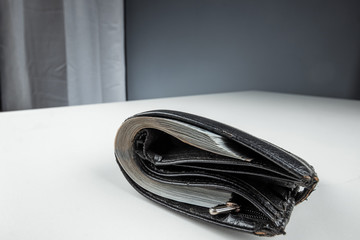 An old wallet full of money lies on a white table. Savings concept pension investment dividends...