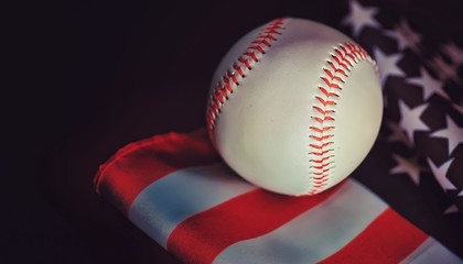 American traditional sports game. Baseball. Concept. Baseball ball and bats on a table with american flag.
