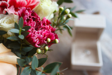 Silver ring and a bouquet of flowers