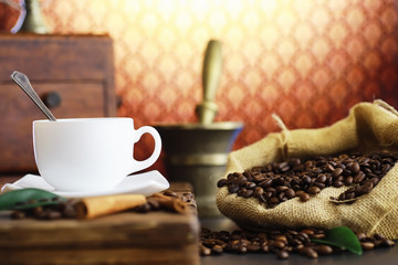 Bag of coffee. Coffee beans roasted on the table. Coffee beans with green leaves for cooking.