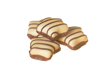 Heap of striped chocolate candies in form of star isolated on white background without shadow. Close-up