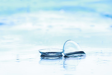 Tools for vision correction. Glasses and lenses with diopters on the background of splashes and...