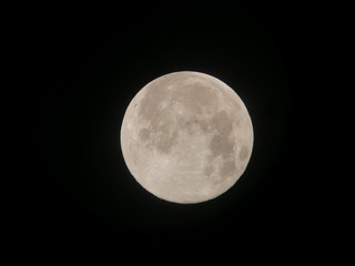 Full moon,view from Refractor telescope and seen in the Eastern Asian hermisphere Thailand. Full moon phase occurs when the Moon is on the opposite side of the Earth from the Sun, called opposition.