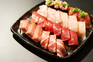 Assorted tuna sushi pack on black background 