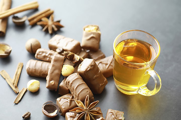 Chocolate bars on a black background in backlight. Chocolate with filling. Sweet sweets for snack and tea.