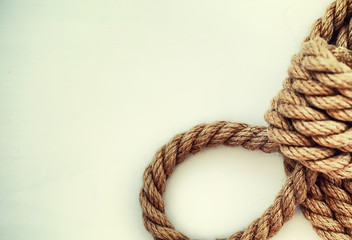Braided thick rope tied in a skein. Hemp rope for decoration and design. Background from a fishing...