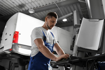 Mechanic doing car diagnostic at automobile repair shop