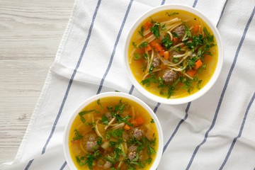 Homemade Sopa a La Minuta in white bowls on a white wooden surface, top view. Flat lay, overhead, from above. Copy space.
